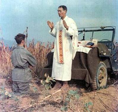 U.S. Army Chaplain Emil Kapaun (right) leads Mass at an impromptu altar set up on his jeep during the Korean War. BBC News