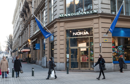 Pedestrians pass a Nokia Oyj mobile communications store in
Helsinki.   (Bloomberg)
