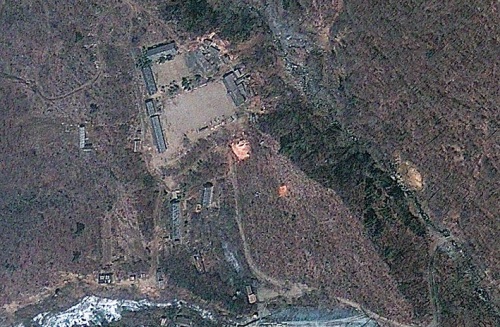 This April 18, 2012 satellite image provided by GeoEye appears to show a train of mining carts, at the lower center of the frame, and other preparations underway at North Korea’s Punggye-ri nuclear test site, but no indication of when a detonation might take place, according to analysis by the U.S.-Korea Institute at Johns Hopkins School of Advanced International Studies. (AP-Yonhap News)