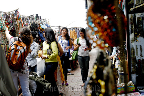 Shoppers walk along the markets in Colaba Causeway in Mumbai.  Bloomberg