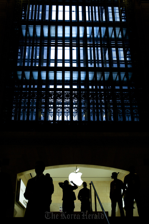 Apple Inc. employees walk through the new Apple retail location in Grand Central Terminal in New York.  Bloomberg