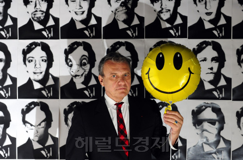 지난달 25일 서울 홍익대학교에서 만난 패션 디자이너 카스텔바작은 사진을 찍는 내내 웃지 않았다. 디자인의 원천을 충돌과 융합에서 찾아온 그는 ‘스마일’ 풍선은 웃고, 자신은 웃지 않아야 ‘대조의 예술’이 완성된다고 말했다.  박해묵 기자/mook@