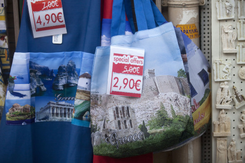 Euro discount signs sit on souvenir bags displayed for sale outside a tourist store in the Plaka district of Athens, Greece, on Tuesday, May 1, 2012. It is "entirely possible" IMF, EU will refuse to make next payment to Greece if new govt doesn't fulfill its commitments, UBS's Stephane Deo says in note to clients before May 6 elections. Photographer: Simon Dawson/Bloomberg
Euro discount signs sit on souvenir bags displayed for sale outside a tourist store in the Plaka district of Athens.  Bloomberg