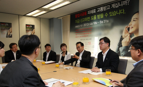<YONHAP PHOTO-0763> 李대통령, 불법사금융 피해신고센터 방문 (서울=연합뉴스) 김병만 기자 = 이명박 대통령이 2일 서울 영등포구 여의도동 금융감독원에 있는 '불법사금융 피해신고센터'를 방문, 주재성 금감원 부원장, 정승원 대검찰청 팀장 등 센터 관계자들과 이야기를 나누고 있다. 2012.5.2 kimb01@yna.co.kr/2012-05-02 15:53:47/ <저작권자 ⓒ 1980-2012 ㈜연합뉴스. 무단 전재 재배포 금지.>
President Lee Myung-bak speaks about the ongoing crackdown on loan sharks with officials of the Financial Supervisory Service and the prosecution during his visit to a call center at the FSS headquarters in Seoul on Wednesday.  Yonhap News
