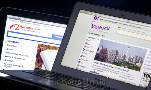 The Yahoo! Inc. and Alibaba Group Holding LTD. websites are displayed on computer monitors for a photograph in New York.  Bloomberg