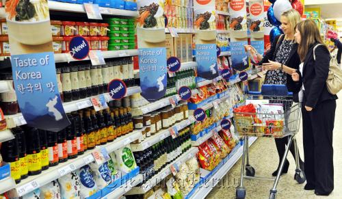 Shoppers look at Korean food products during the Taste of Korea at Tesco Extra New Malden store in New Malden, the U.K.       Homeplus