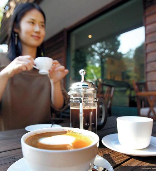 A woman enjoys a cup of coffee at Samcheong-dong, central Seoul. (The Korea Herald)