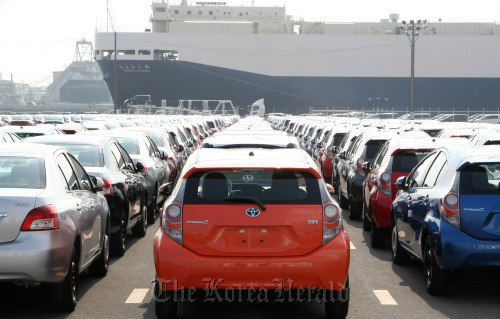 Toyota Motor Corp. automobiles sit parked ahead of shipping at the port of Sendai, Miyagi Prefecture, Japan.  Bloomberg