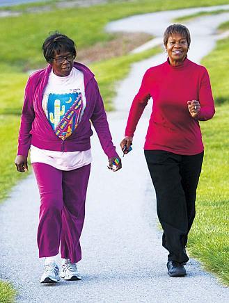 Margie Warden (left) of Edwardsville, and Gladys Johnson, of
Kansas City, Kansas, walk along a trail at Kansas City Kansas
Community College, April 26. Warden and a group of friends
have been walking 10 kilometers a day for 41 years. (MCT)