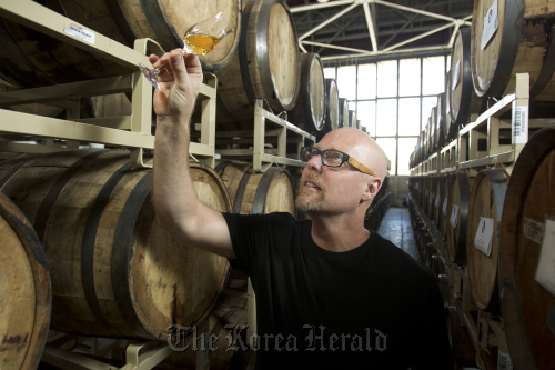 Lance Winters, owner and distiller of St. George Spirits in Alameda, California, checks the color of his hand-crafted whiskey at the company’s headquarters, April 17.  Contra Costa Times/MCT