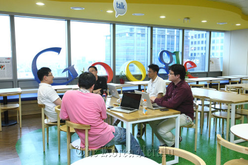 Google Korea employees chat at the company’s office in Yeoksam-dong, southern Seoul.  Google Korea