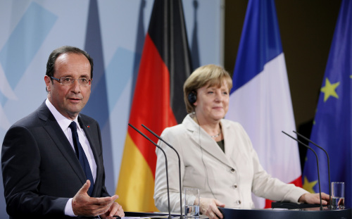 Francois Hollande, France's president, left, speaks as Angela Merkel, Germany's chancellor, listens during their joint news conference following the Franco-German summit at the German Chancellory in Berlin, Germany, on Tuesday, May 15, 2012. Merkel and Hollande told Greeks they were ready to help support economic growth while warning that the coming election will be a referendum on Greece's euro membership. Photographer: Michele Tantussi/Bloomberg *** Local Caption *** Francois Hollande; Angela Merkel
Francois Hollande, France’s president, left, speaks as Angela Merkel, Germany’s chancellor, listens during their joint news conference following the Franco-German summit at the German Chancellory in Berlin on Tuesday.  Bloomberg