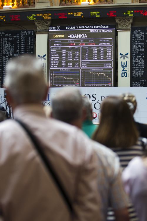 Visitors look at the share price information for Bankia SA inside the Bolsas y Mercados stock exchange in Madrid, Spain, on Thursday, May 17, 2012. Spain sold the maximum amount of notes targeted today as borrowing costs rose and 10-year bond yields approached levels that drove nations including Greece and Portugal into bailouts. Photographer: Angel Navarette/Bloomberg
Visitors look at the share price information for Bankia SA inside the Bolsas y Mercados stock exchange in Madrid on Thursday.   Bloomberg