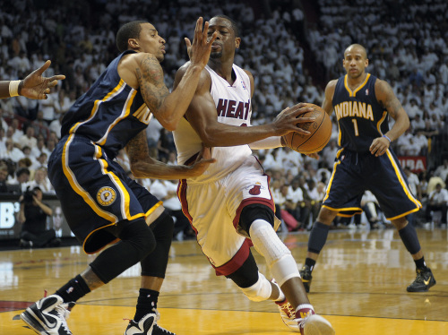 Miami Heat guard Dwyane Wade drives on Indiana Pacers guard George Hill in the third quarter on Tuesday.  MCT