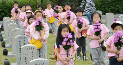 24일 국립서울현충원에서 열린 '한사람 한송이 헌화'행사에 참여한 어린이집 아동들이 묘지에 헌화를 하고 있다.이 행사는 동작구가 매년 참여희망자를 모집 행사를 주최하며 올해는 3만 5백송이의 참여신청이 들어왔다. <br />정희조 기자/checho@heraldm.com 0524
24일 국립서울현충원에서 열린 '한사람 한송이 헌화'행사에 참여한 어린이집 아동들이 묘지에 헌화를 하고 있다.이 행사는 동작구가 매년 참여희망자를 모집 행사를 주최하며 올해는 3만 5백송이의 참여신청이 들어왔다.
정희조 기자/checho@heraldm.com 0524
꽃을 바친다는 헌화(獻花)는 ‘감사함’의 표현이다. 서울 동작동 국립서울현충원에서 ‘한 사람 한 송이 헌화’ 행사가 열렸다. 서울 동작구가 해마다 참여 희망자를 모집해 헌화하는 이 행사는 올해 3만500송이를 헌화하고 싶다는 참여 신청이 들어왔다. 24일 오전 어린이집 아동들이 현충원에 헌화를 하고 있다.  정희조 기자/checho@heraldm.com