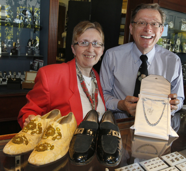 Richard John (right) and JoAnne Cawley with shoes worn by Liberace (left) and Bob Hope and a necklace worn by Lana Turner are part of a large collection of clothes and gowns from Hollywood movie stars at Hood & Hoover Jewelry on display on May 11 in Stow, Ohio.   (Paul Tople/Akron Beacon Journal/MCT)