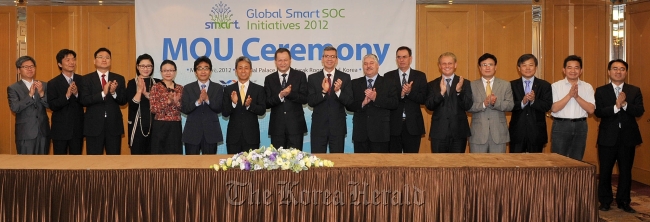 Executives from IT companies pose during a gathering of the Global Smart SOC Initiatives 2012 at a hotel in Seoul on May 24-25.  KOTRA