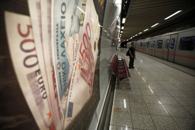 A passenger waits on a metro train platform near a Greek euro currency advertisment in Athens, Greece, on Thursday, May 24, 2012. European leaders tied their next steps on the financial crisis to the outcome of a bitterly contested election in Greece that may determine whether the 17-nation euro currency splinters. Photographer: Kostas Tsironis/Bloomberg
A passenger waits on a metro train platform near a Greek euro currency advertisment in Athens.  Bloomberg