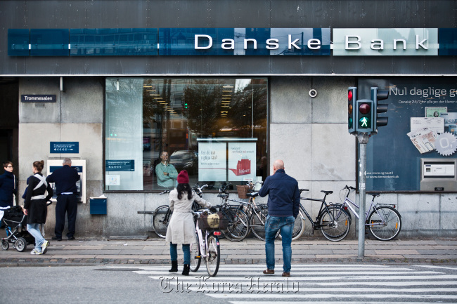 Pedestrians pass a Danske Bank branch in Copenhagen, Denmark.  Bloomberg