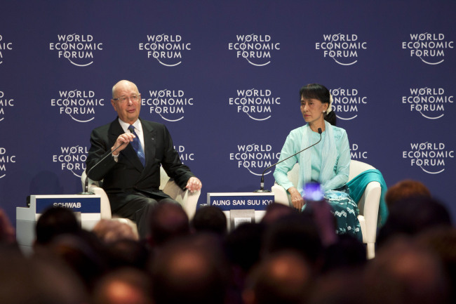 Aung San Suu Kyi, Myanmar's opposition leader, right, listens while Klaus Schwab, founder and chairman of the World Economic Forum, speaks at the World Economic Forum on East Asia 2012 in Bangkok, Thailand, on Friday, June 1, 2012. Suu Kyi said the sustainability of political reforms in Myanmar will depend on the commitment of the military and the nation. Photographer: Brent Lewin/Bloomberg *** Local Caption *** Aung San Suu Kyi; Klaus Schwab
Aung San Suu Kyi, Myanmar’s opposition leader (right) listens while Klaus Schwab, founder and chairman of the World Economic Forum, speaks at the World Economic Forum on East Asia 2012 in Bangkok on Friday.  Bloomberg