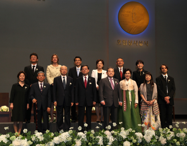 Samsung Electronics chairman Lee Kun-hee (fourth from right, front row) and Prime Minister Kim Hwang-sik (fourth from left, front row) pose for a photo with Ho-Am Prize recipients and their family members at an event in Seoul on Friday.  Samsung Group