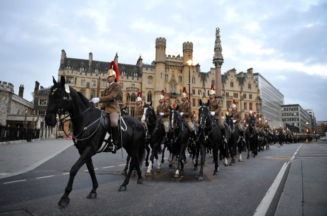The Household Cavalry Mounted Regiment, HCMR, form up in the early hours of this morning Friday at the Palace of Westminster, London during the Queens Diamond Jubilee Procession rehearsal. The patriotic bunting is ready, the golden carriage on standby, the boats freshly painted, the shops filled with royals souvenirs. The normal ebb and flow of British life gives way in the next four days to a series of street parties, flotillas, outdoor concerts and finally the appearance of an elderly great-grandmother on her balcony to wave to her subjects. The pageantry is very grand and very British. (AP-Yonhap)