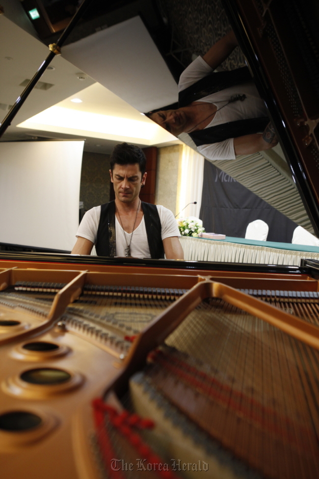 Maksim Mrvica plays the piano at a press conference in Seoul on Monday.  CM Interactive