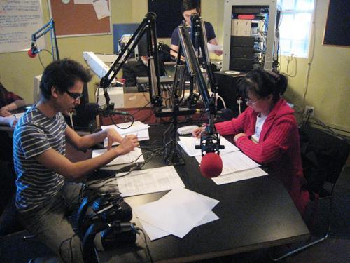 Voice of Korea’s English-language host Ravi Kalsi (left) and Korean host Dianna Chon reading their scripts during a live broadcast.  Yonhap News