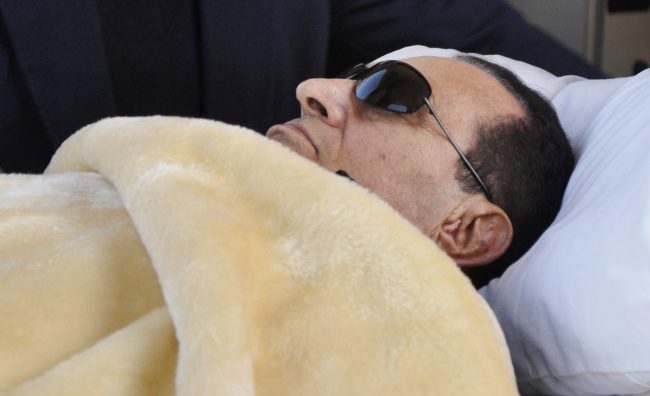 Former Egyptian President Hosni Mubarak is wheeled into court in Cairo.  (AP-Yonhap News)