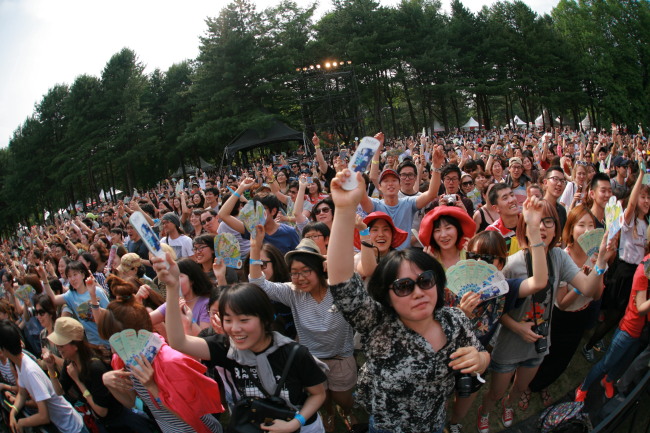 The crowd jumps in time with the music at Rainbow Island Music and Camping on Nami Island on Saturday. Rainbow Island Music and Camping