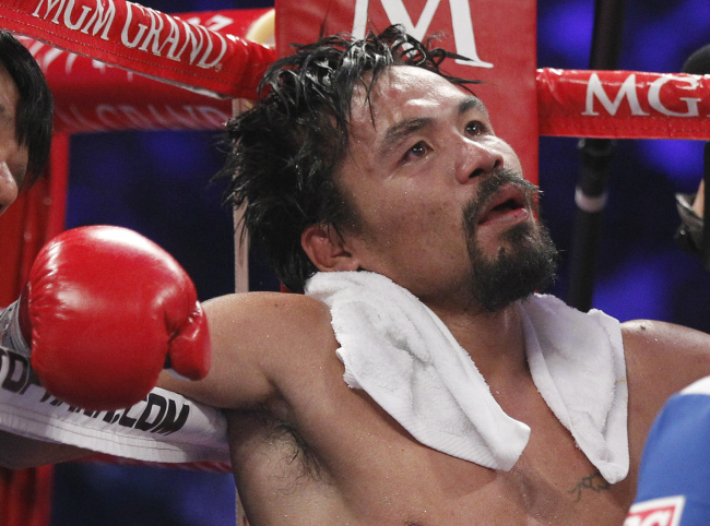Manny Pacquiao sits in his corner following the 11th round on Saturday.  AP-Yonhap News