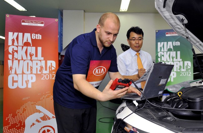 A mechanic participates in a practical test at a training institute in Cheonan, Gyeonggi Province, Wednesday, as part of the 6th Kia Skill World Cup 2012. The three-day auto maintenance and repair competition opened Tuesday with some 100 participants from 45 countries in attendance. (Hyundai Motor Group)