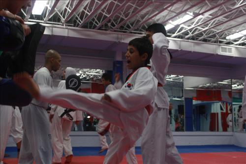 Sajiad Mohammed Kaittan, a 15-year-old Iraqi boy, practices a taekwondo kick at a gym in Maryland.