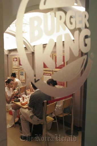 Customers eat their meals at a Burger King restautant in Shanghai.  Bloomberg