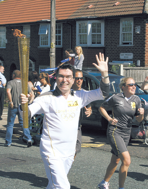 Former British Ambassador Martin Uden carries the Olympic torch in Liverpool, U.K. (British Embassy)
