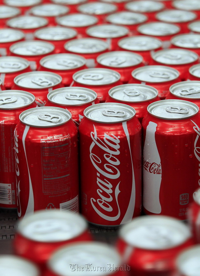 Coca-Cola Co. cans move along a conveyor belt at the company’s Swire bottling plant in Salt Lake City, Utah.  Bloomberg