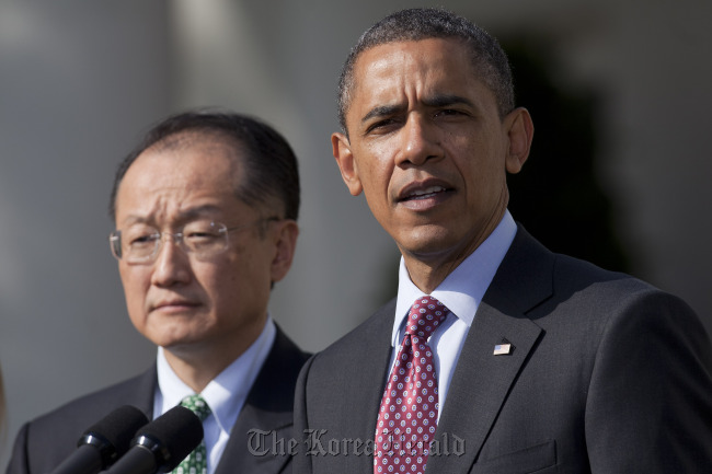 U.S. President Barack Obama (right) introduces Jim Yong Kim, president of Dartmouth College, as a nominee to become president of the World Bank at the White House in Washington, D.C., on March 23.  Bloomberg