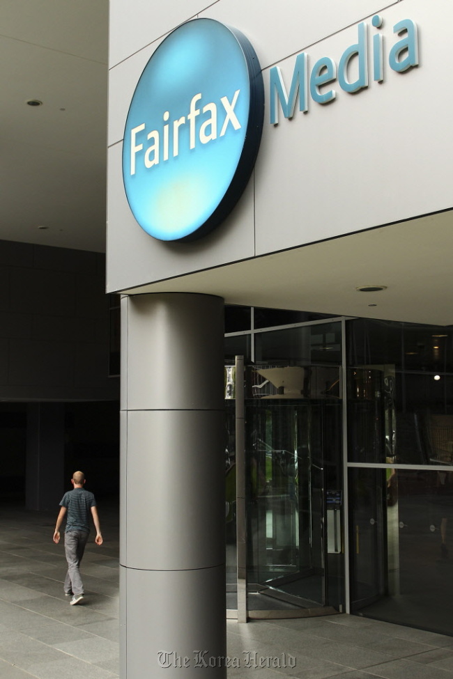 A man walks into Fairfax Media Ltd.’s offices in Sydney.  Bloomberg