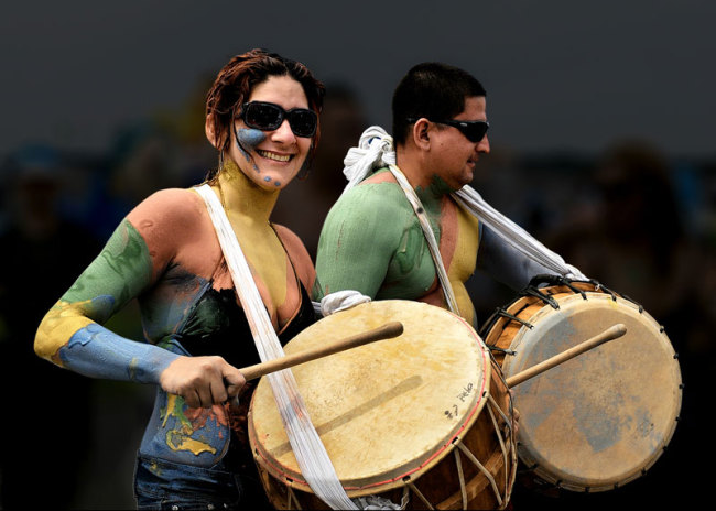 Top and right Revellers enjoy previous Mud Festivals