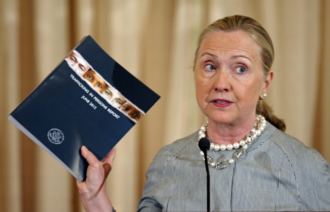 Secretary of State Hilary Rodham Clinton holds up a copy of the 2012 Trafficking in Persons Report.  AP-Yonhap News