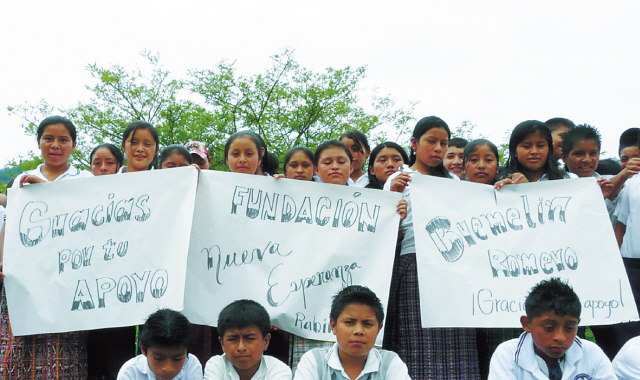 Students from the New Hope Community Bilingual Institute in Guatemala hold up signs of thanks to support Bremelin Romero’s fund-raising efforts on their behalf.(The New Hope Foundation)