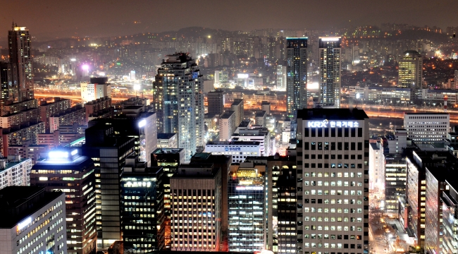 Offices remain lit up into the night in Yeoido, Seoul’s finacial district. The nation’s demanding work culture means that many employees work way beyond regular office hours.  The Korea Herald