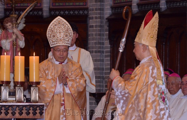 Archbishop Andrew Yeom Soo-jung (left) celebrates his inaugural Mass at Myeongdong Cathedral in Seoul on Monday. On the right is Cardinal Nicholas Cheong Jin-suk.
