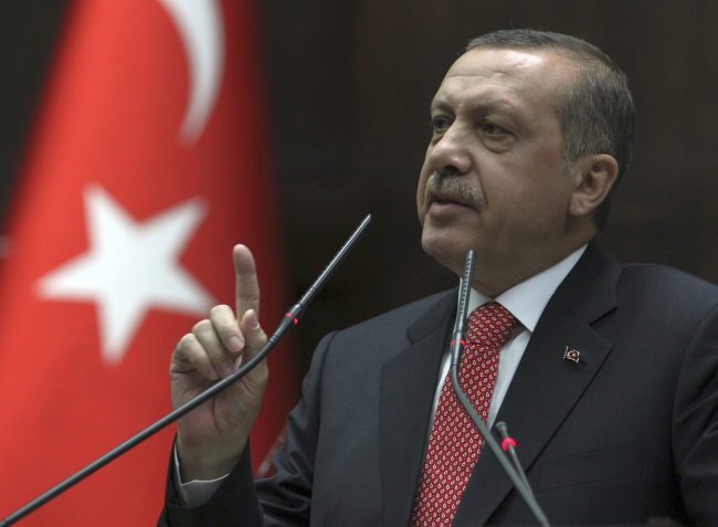 Turkish Prime Minister Recep Tayyip Erdogan addresses the lawmakers of his Justice and Development Party at the parliament in Ankara on Tuesday.  (AP-Yonhap News)