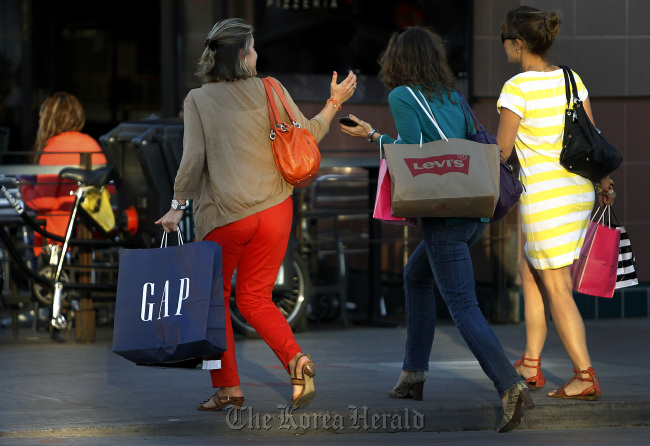 Pedestrians carry shopping bags at the Third Street Promenade in Santa Monica, California.  Bloomberg