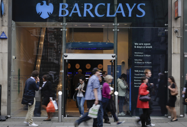 Pedestrians pass a Barclays Plc bank branch in London, U.K., on Monday, July 2, 2012. Barclays Plc Chairman Marcus Agius resigned after the bank was fined a record 290 million pounds ($455 million) for trying to rig interest rates in a bid to head off pressure for Chief Executive Officer Robert Diamond to quit. Photographer: Jason Alden/Bloomberg
Pedestrians pass a Barclays bank branch in London on Monday.    Bloomberg