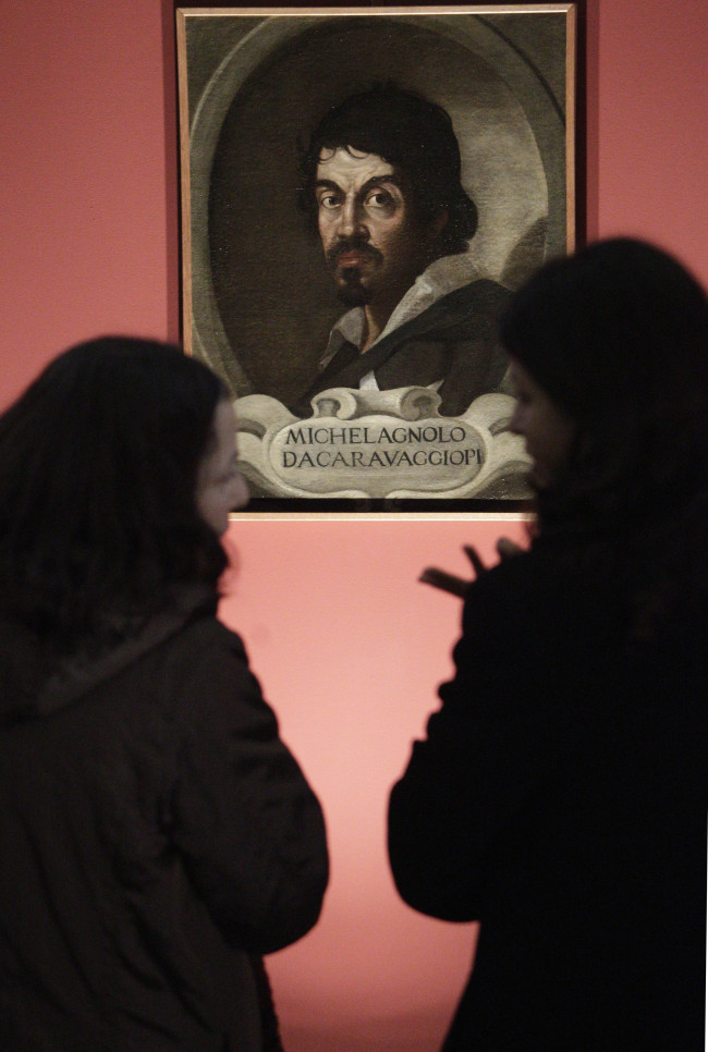 Visitors admire the portrait of Caravaggio by an unknown painter during an exhibit in February 2011 in Rome. AP-Yonhap News