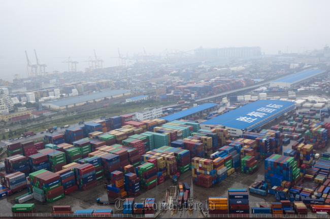 Containers are stacked at the Dayaowan Bonded Port Area in Dalian, Liaoning Province, China. Bloomberg