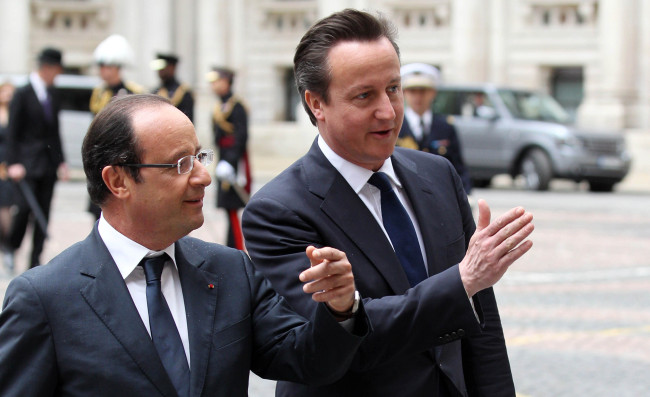 French President Francois Hollande (left) is greeted by Britain’s Prime Minister David Cameron at the Foreign and Commonwealth Office in London on Tuesday.  AP-Yonhap News