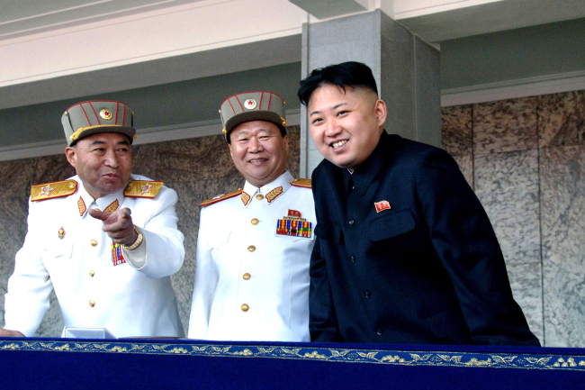 North Korean leader Kim Jong-un (right) smiles with Korean People’s Army Vice Marshal Choe Ryong-hae (center) and the military’s General Staff Chief Ri Yong-ho during a military parade in Pyongyang on April 15.    AP-Yonhap News